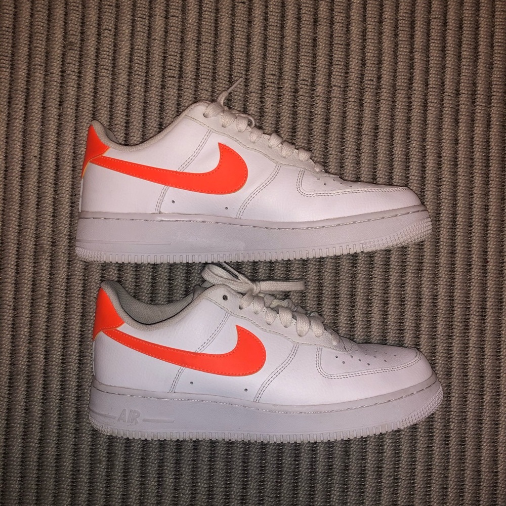 White and orange Air Force 1s.
